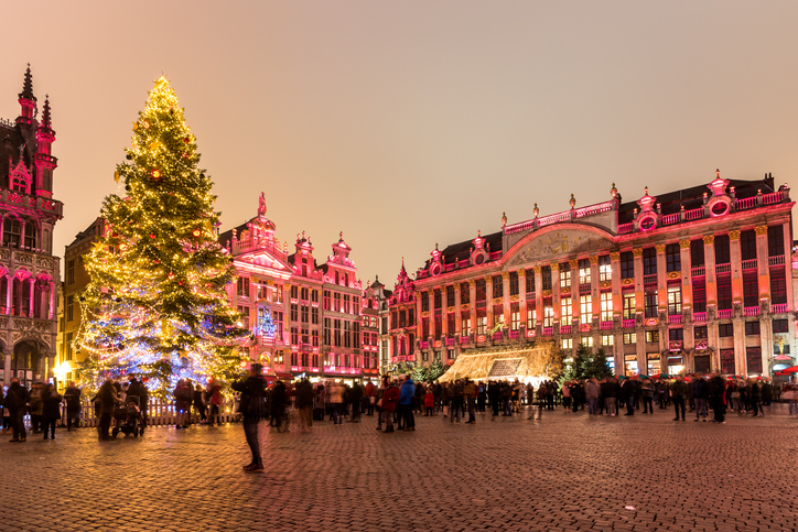 http://Christmas%20Tree%20In%20A%20Crowded%20Square%20Surrounded%20By%20Illuminated%20Historic%20Buildings%20At%20Night.%20Brussels,%20Belgium.
